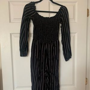 A Long sleeve long pant stripped jumpsuit. Stretchy bodice with pockets.